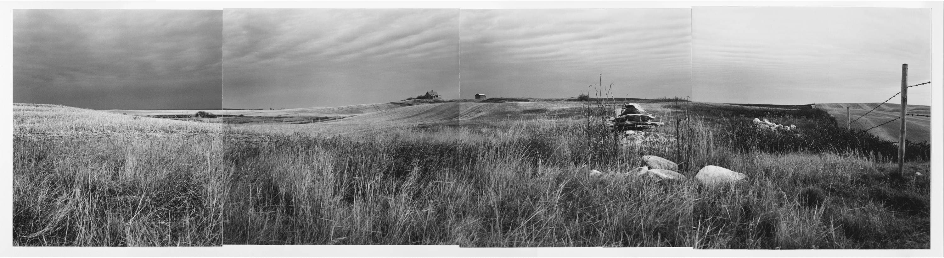 Black and white four panel panorama: grassy landscape with big white rocks on one side, dramatic prairie sky with a small homestead seen in the distance.