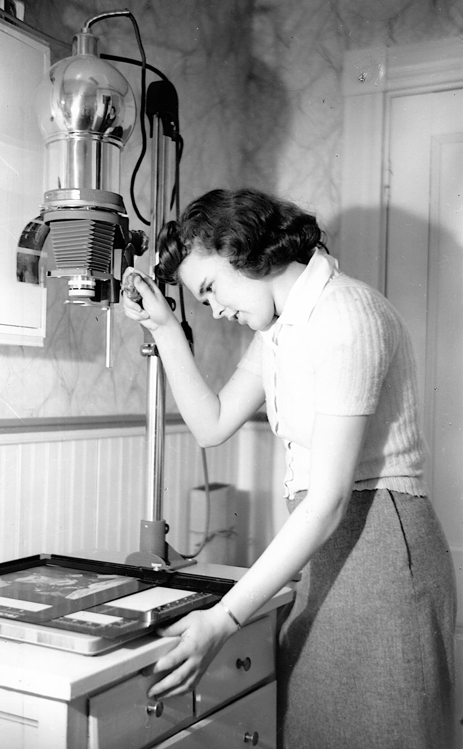Thelma Pepper about 19 years old operating a photo printing stand.